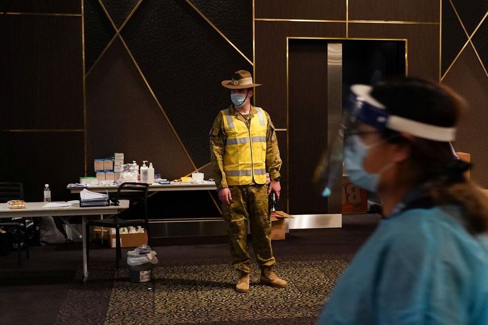 An Australian Defence Force member watches over a coronavirus disease (COVID-19) vaccination clinic at the Bankstown Sports Club as the city experiences an extended lockdown, in Sydney, Australia, August 3, 2021. REUTERS/Loren Elliott

