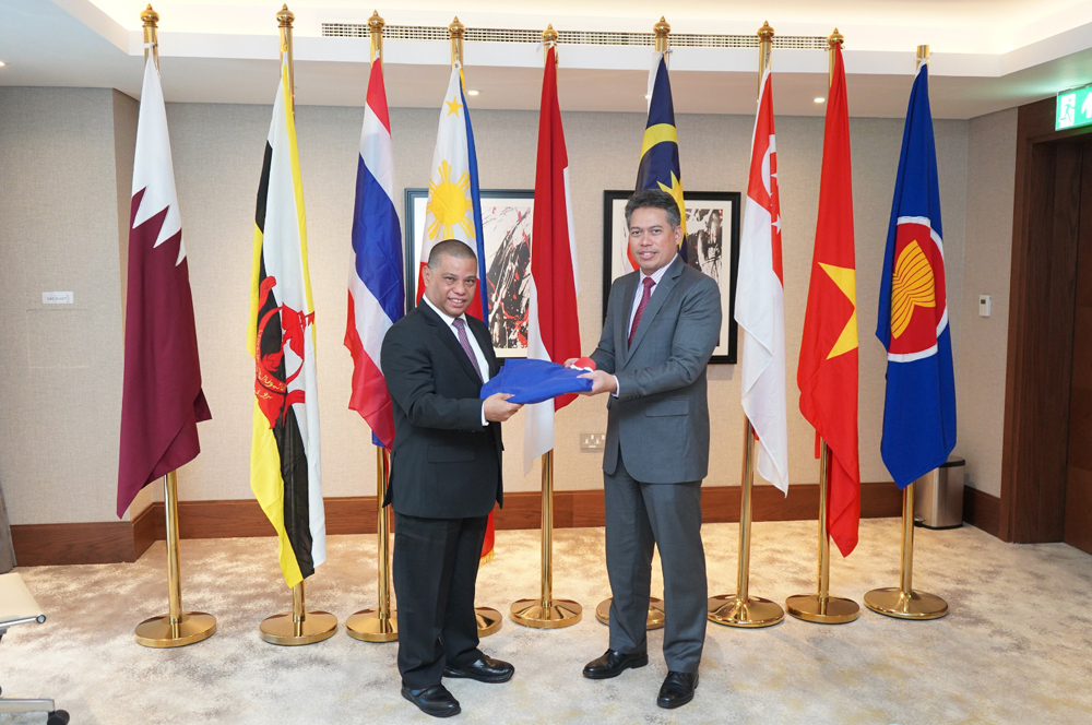 Indonesian Ambassador Ridwan Hassan handing over the ASEAN flag to Malaysian Ambassador Zamshari Shaharan as the new Chairman of ASEAN Committee in Doha.