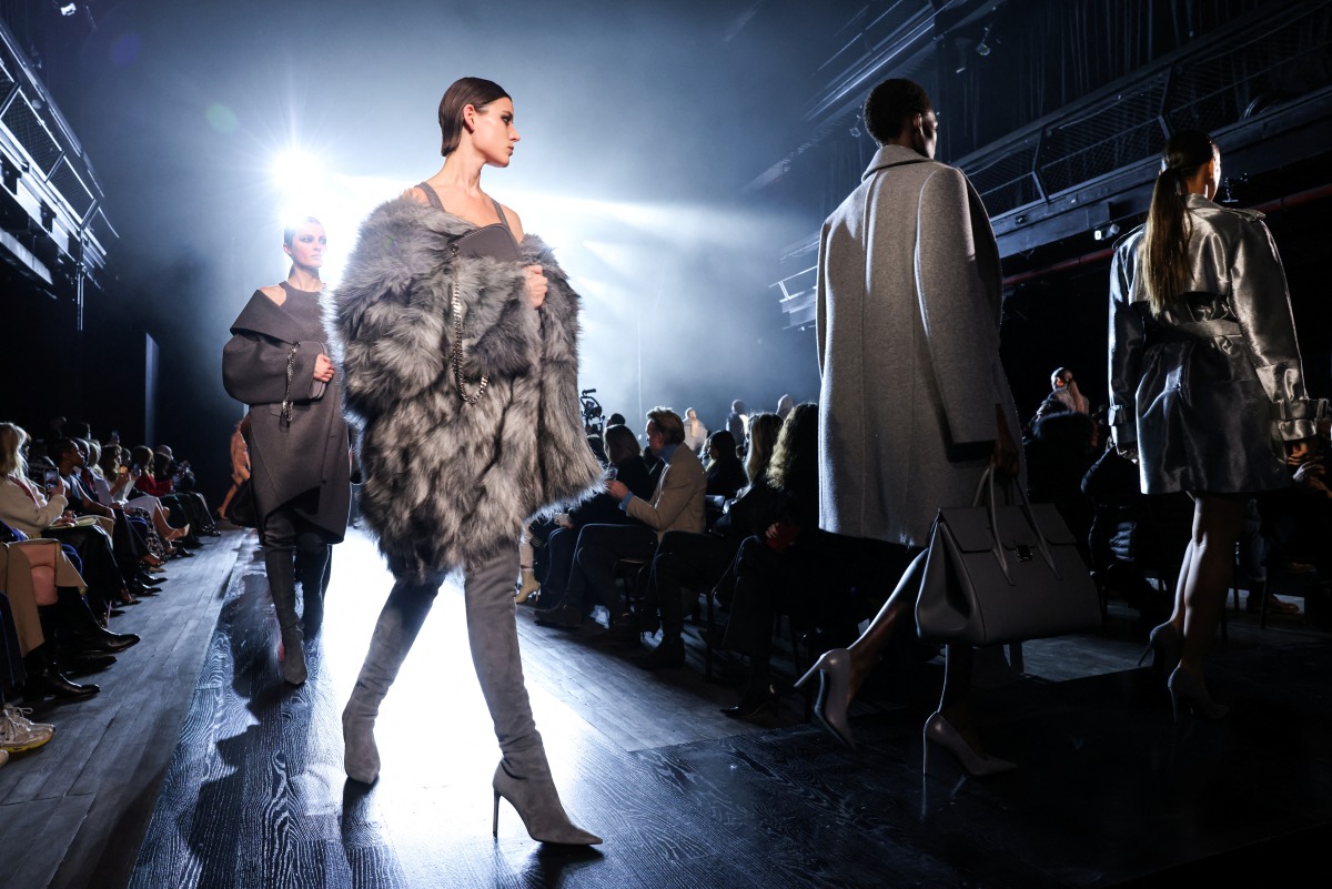 Models present creations from the latest collection by Michael Kors during Fashion week in New York City, New York, U.S., February 15, 2022. REUTERS/Caitlin Ochs
