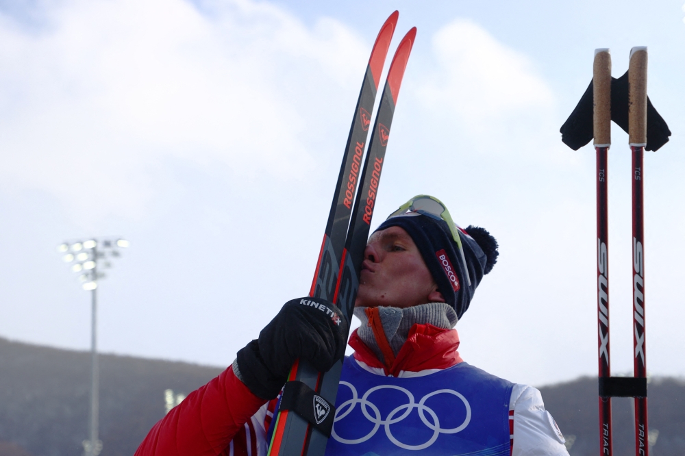 Alexander Bolshunov of the Russian Olympic Committee celebrates winning gold. REUTERS/Marko Djurica
