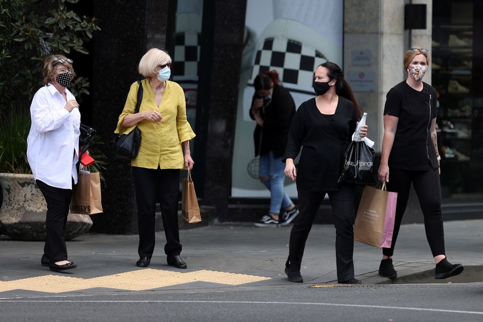 Shoppers walk through a retail district in the wake of coronavirus disease (COVID-19) lockdown restrictions being eased in Auckland, New Zealand, November 10, 2021. REUTERS/Fiona Goodall

