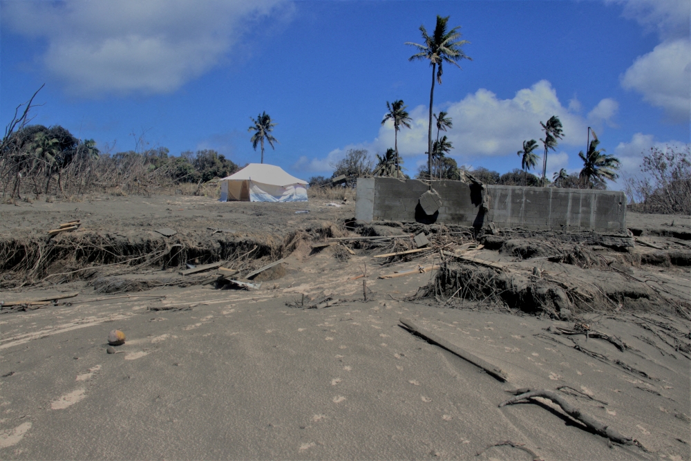 A general view shows damaged buildings and landscape covered with ash following the volcanic eruption and tsunami in Kanokupolu, Tonga, January 23,2022. Picture taken January 23, 2022. Tonga Red Cross Society/Handout via REUTERS 