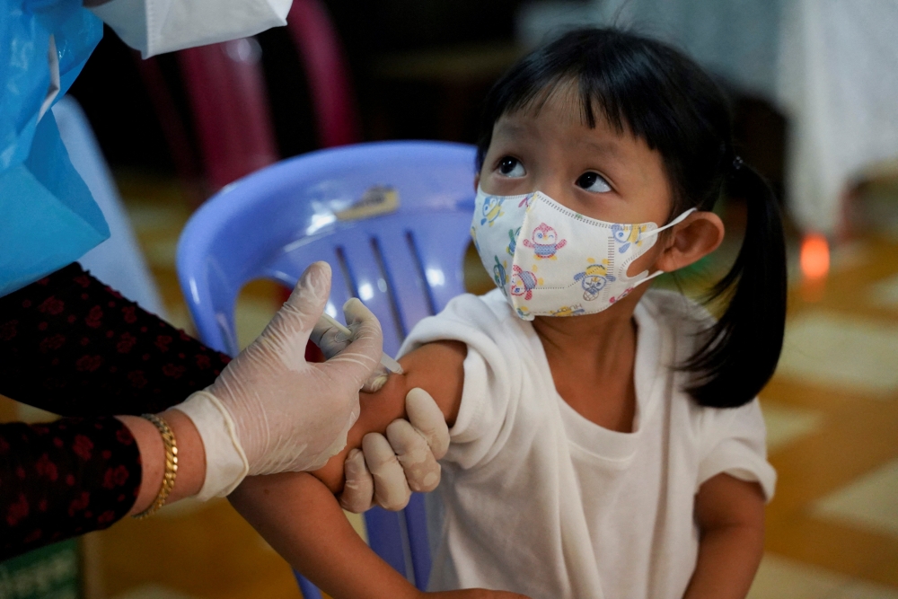 A child receives a vaccine against the coronavirus disease (COVID-19) at a health center as Cambodia begins to vaccinate children aged 3 to 5 years old, in Phnom Penh, Cambodia, February 23, 2022. REUTERS/Cindy Liu