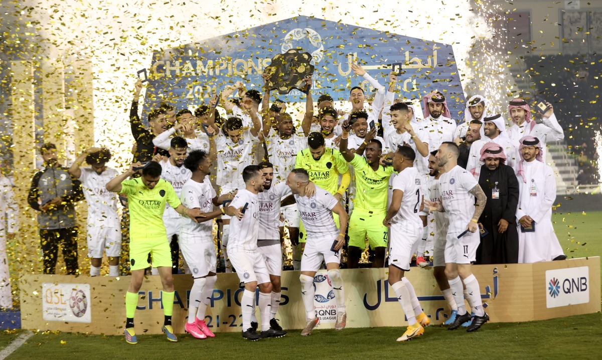 Al Sadd players and officials celebrate with the Falcon Shield after being crowned the QNB Stars League champions. 