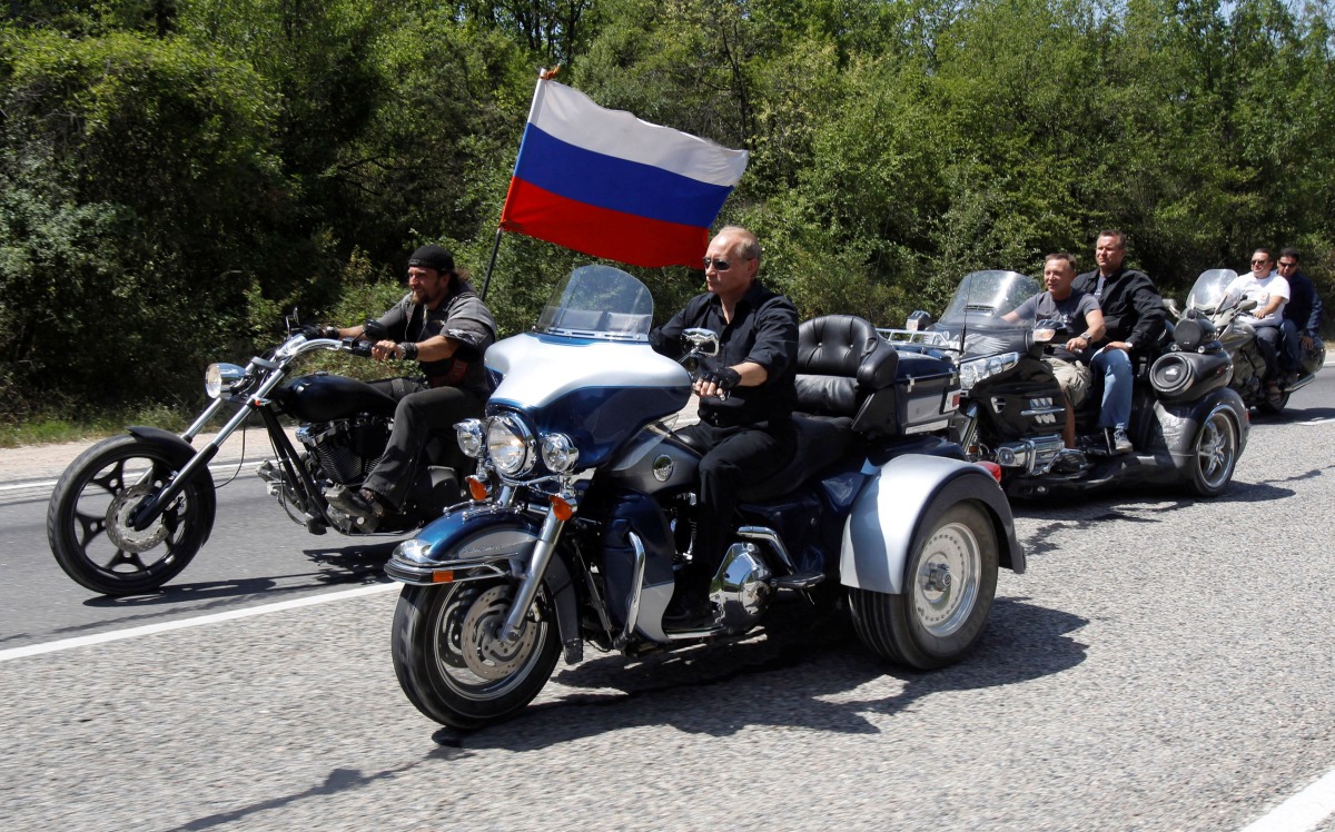 FILE PHOTO: Russia's Prime Minister Vladimir Putin (2nd L) rides a Harley Davidson Lehman Trike as he arrives for a meeting with Russian and Ukrainian bikers at their camp near Sevastopol in Ukraine's Crimea, July 24, 2010. REUTERS/Sergei Karpukhin/File Photo

