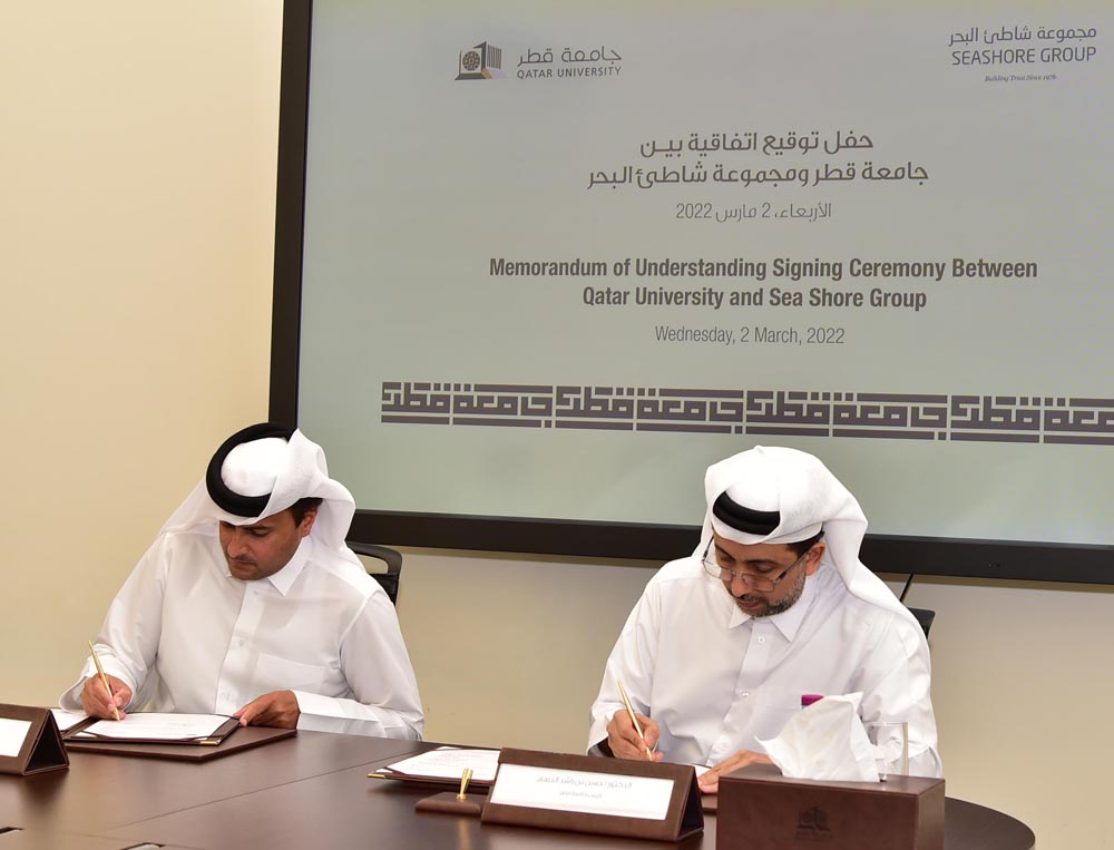 Dr. Hassan Al Derham (right), President of Qatar University, and Salem bin Saeed Al Muhannadi, CEO of Seashore Group, signing the MoU.
