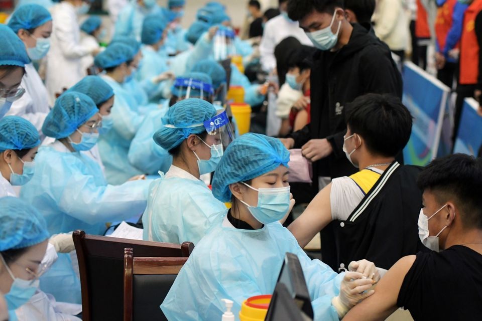 Medical workers inoculate students with the vaccine against the coronavirus disease in Qingdao. Reuters