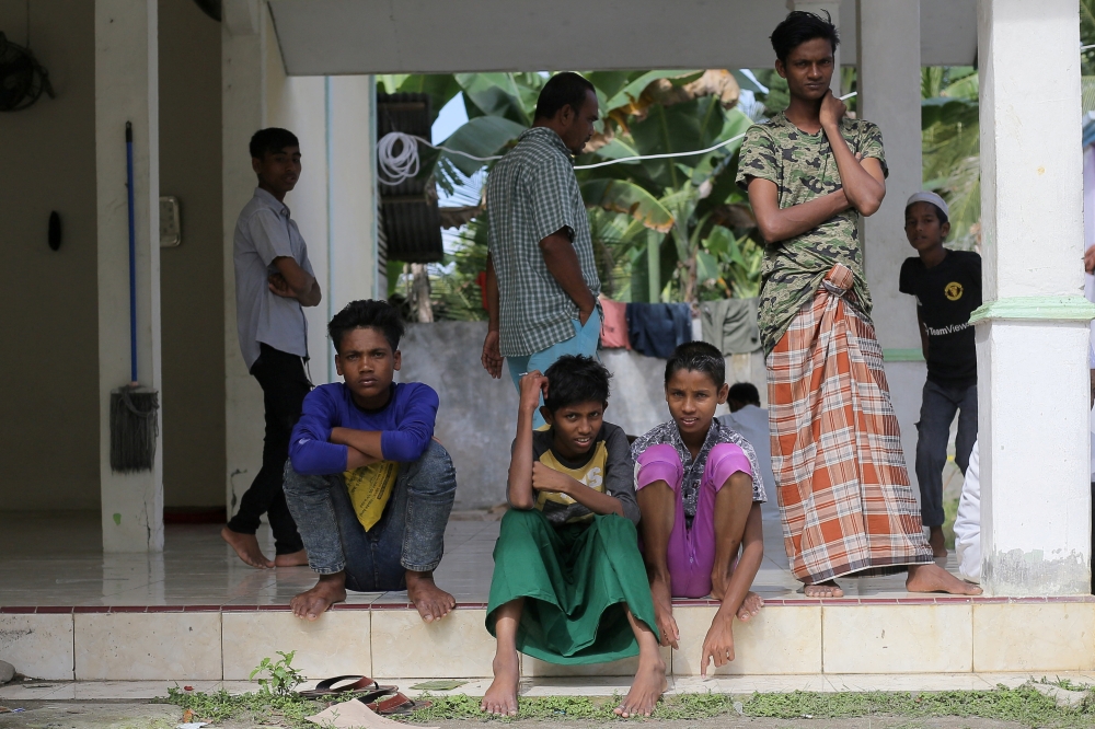 Rohingya refugees among the 114 fresh arrivals sitting in a temporary shelter in Bireuen, Aceh province, Indonesia, March 6, 2022. 