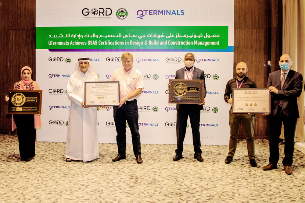 Officials with GSAS certificates during a ceremony.