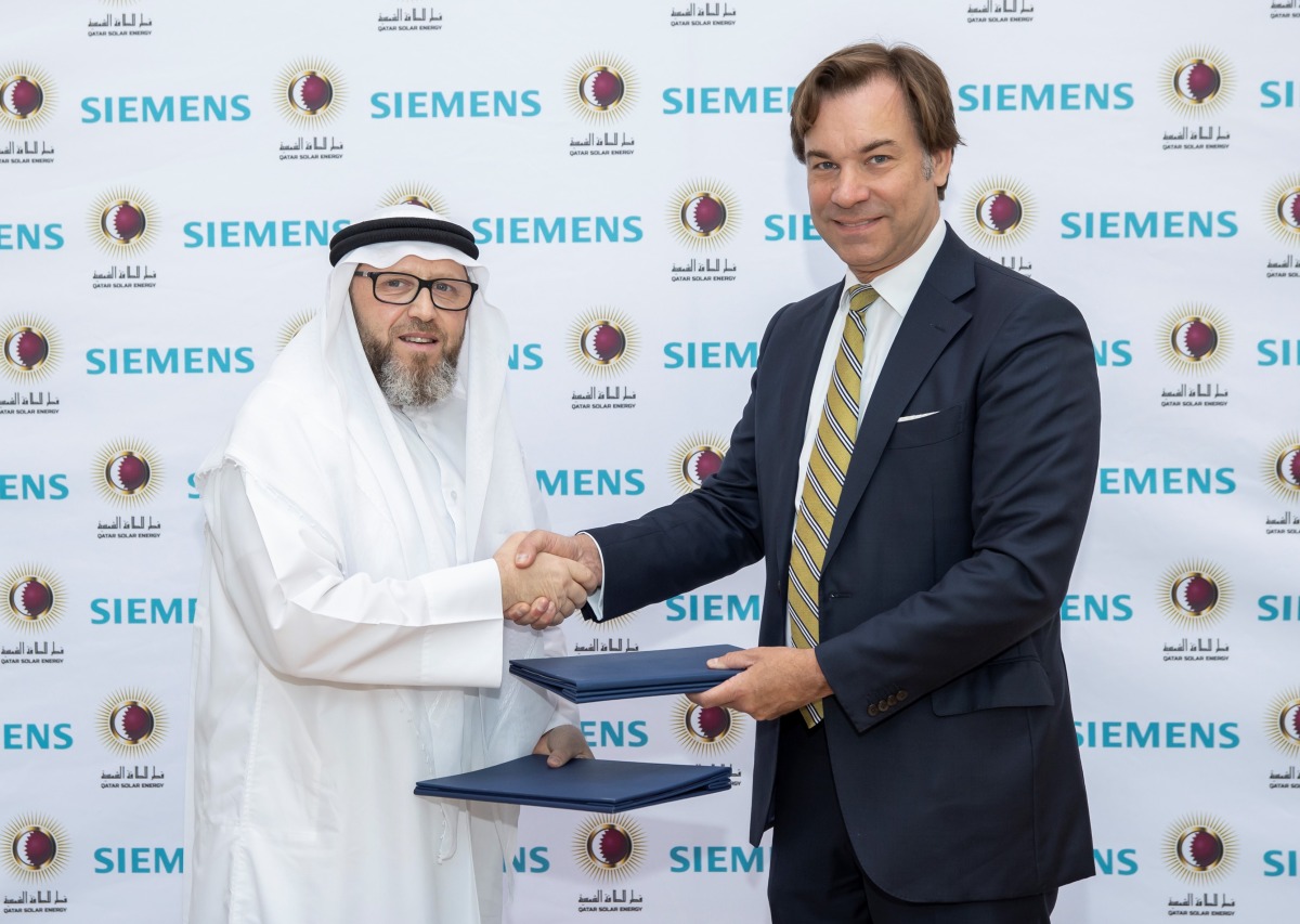 Officials from Siemens and Qatar Solar Energy during the agreement signing ceremony.
