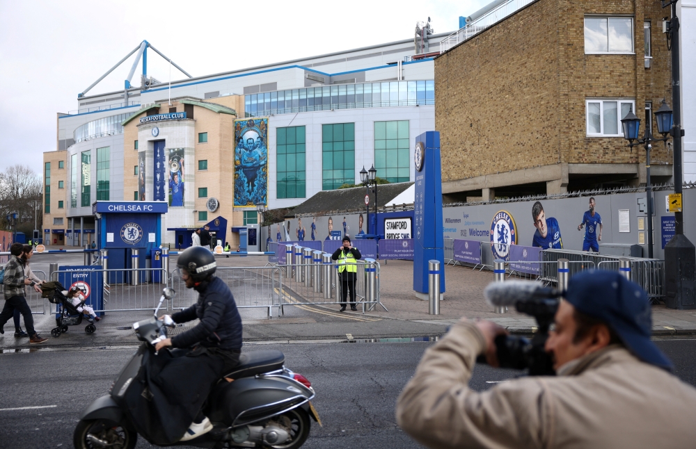 A cameraman films outside Chelsea Football Club's stadium, Stamford Bridge, following Britain's imposing of sanctions on the club's Russian owner, Roman Abramovich, in London, Britain, March 12, 2022. REUTERS/Henry Nicholls