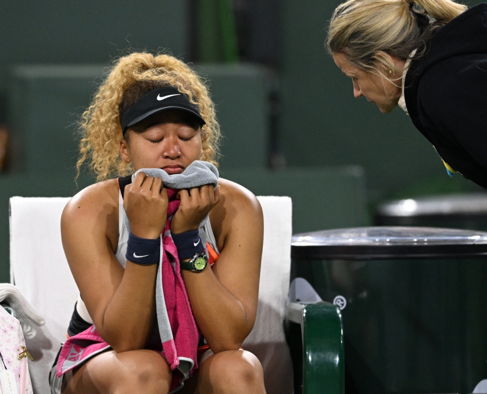 Naomi Osaka (JPN) wipes her face as she talks to referee Claire Wood after a spectator disrupted play, before the start of her 2nd round match against Veronika Kudermetova (RUS) at the Indian Wells Tennis Garden. Jayne Kamin-Oncea-USA TODAY Sports