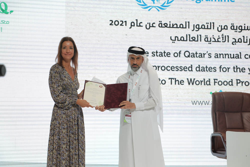 Youssef Khaled Al Khulaifi, Director of the Agricultural Affairs Department, handing over the contribution to Caterina Galluzzi, WFP Deputy Director for the GCC region, at a ceremony yesterday.