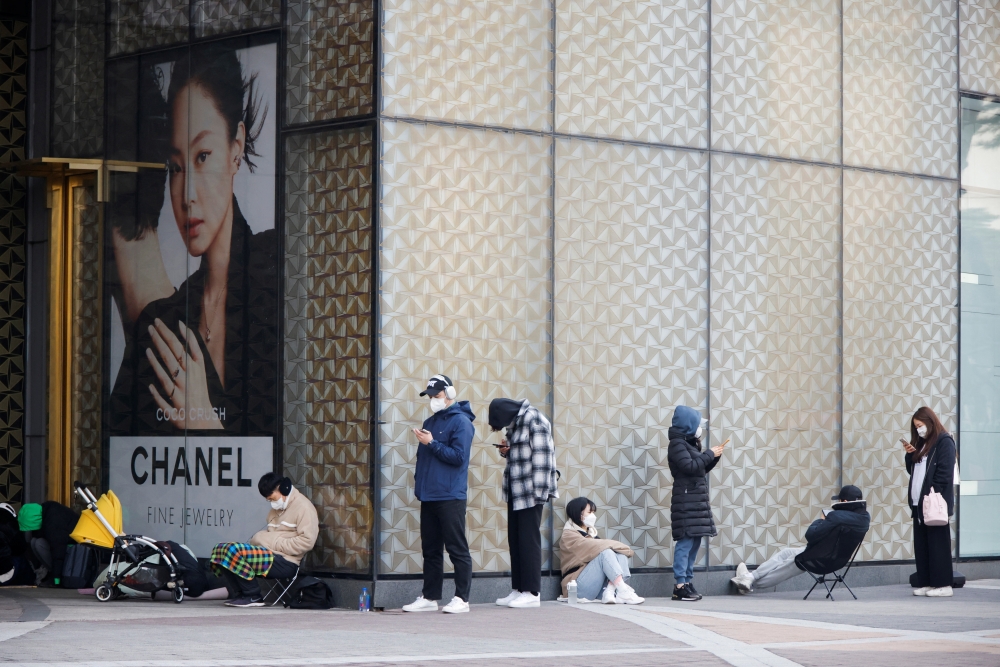 Shoppers line up outside a Chanel store in Seoul, South Korea, March 16, 2022. Picture taken March 16, 2022. REUTERS/Heo Ran