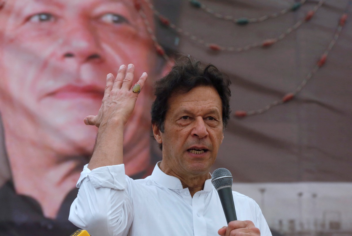 FILE PHOTO: Imran Khan, chairman of the Pakistan Tehreek-e-Insaf (PTI), gestures while addressing his supporters during a campaign meeting ahead of general elections in Karachi, Pakistan, July 4, 2018. REUTERS/Akhtar Soomro/File Photo
