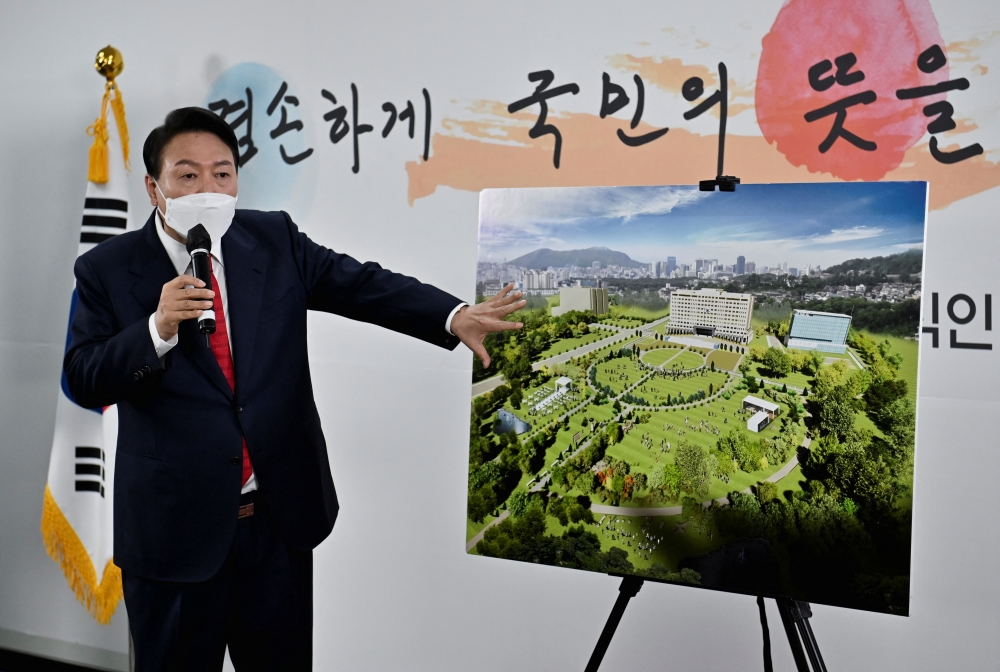South Korea's president-elect Yoon Suk-yeol shows a bird's eye view of his planned relocation of the presidential office during a news conference, at his transition team office, in Seoul, South Korea, March 20, 2022.Jung Yeon-je/Pool via REUTERS