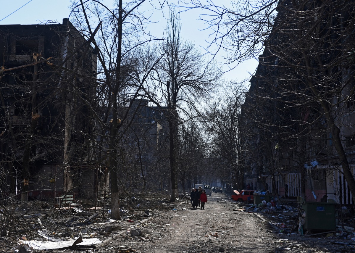 Local residents walk near residential buildings which were damaged during Ukraine-Russia conflict in the besieged southern port city of MARIUPOL, Ukraine March 18, 2022. REUTERS/Stringer TPX IMAGES OF THE DAY
