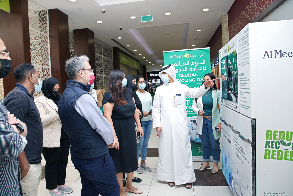 Al Meera officials during an activity to mark Global Recycling Day at a store.