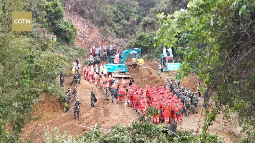 Rescuers work at the site where a China Eastern Airlines Boeing 737-800 plane, flight MU5735, crashed in Wuzhou, Guangxi Zhuang Autonomous Region, China, in this still image taken from a footage March 22, 2022. Video taken March 22, 2022. CGTN via REUTERS