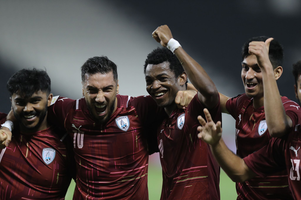 Al Wakrah players celebrate their victory.
