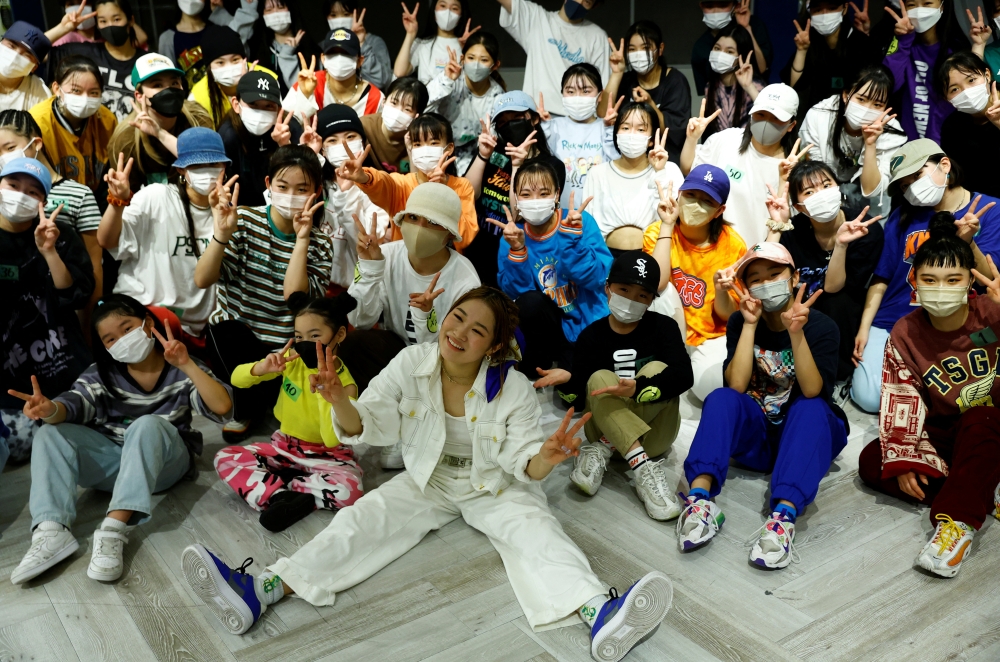 Japanese dancer ReiNa take photos with her students after her dance class in Tokyo, Japan February 26, 2022. Picture taken on February 26, 2022. REUTERS/Kim Kyung-Hoon