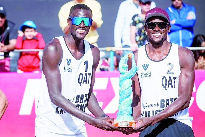 Qatar's Cherif Younousse and Ahmed Tijan with the winner's trophy.