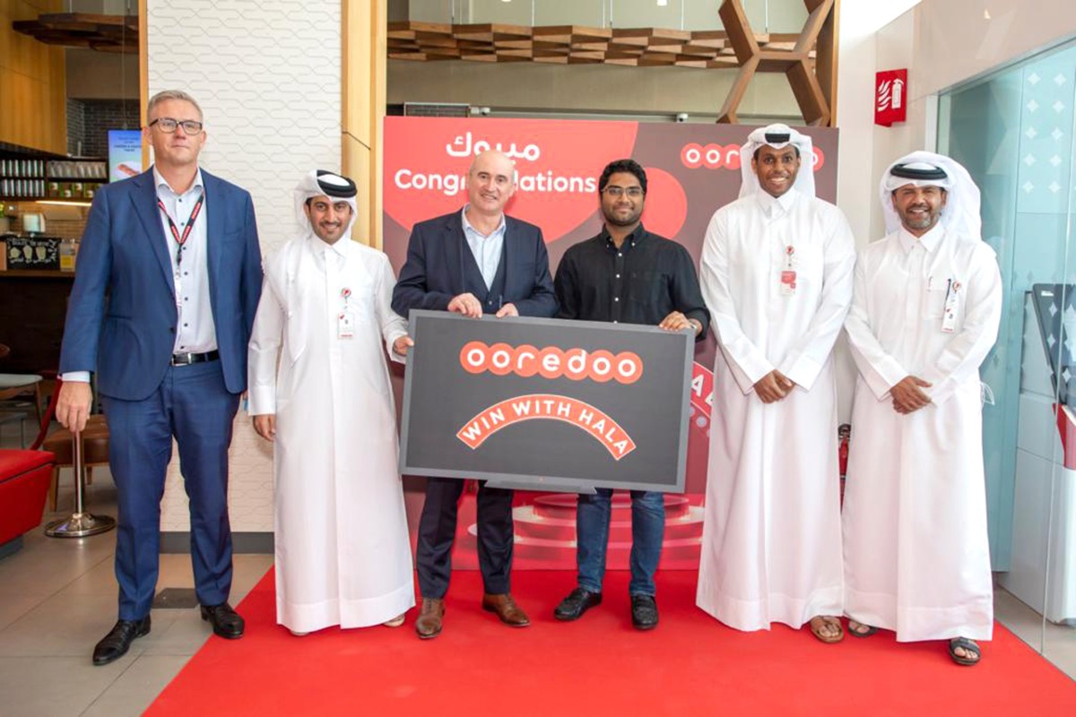 One of the winners of  'Win with Hala campaign', with Ooredoo officials.
