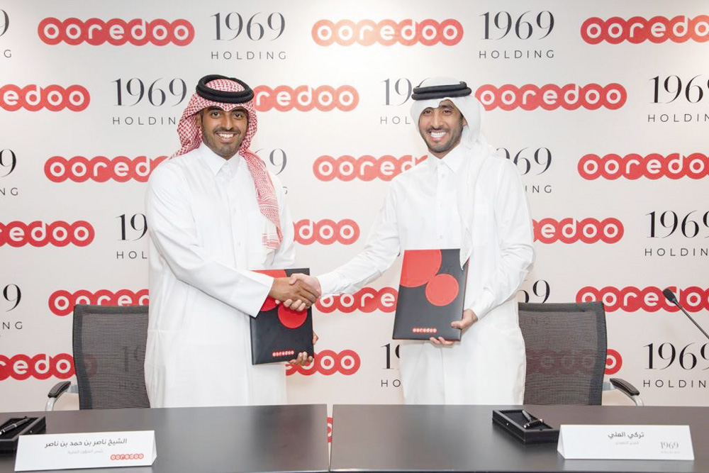 Officials from Ooredoo and 1969 Holding during the partnership signing event. 