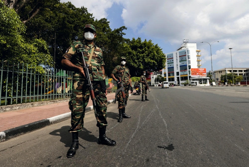 Sri lankan army soldiers stand guard at a checkpoint after the government imposed a curfew following a clash between police and protestors near Sri lankan President Gotabaya Rajapaksa's residence during a protest last Thursday, amid the country's economic crisis, in Colombo, Sri lanka April 3, 2022. REUTERS/