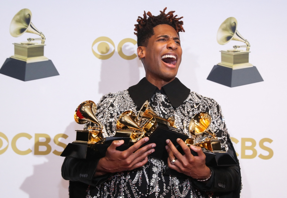 Jon Batiste poses with their Grammys for Best American Roots Performance for 