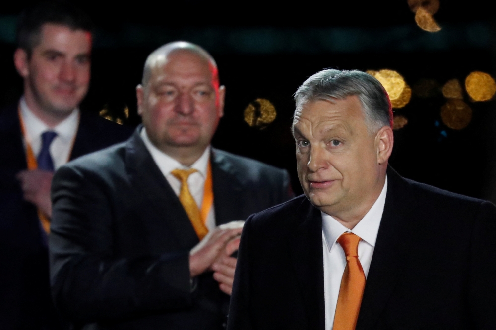 Hungarian Prime Minister Viktor Orban reacts in front of supporters after the announcement of the partial results of parliamentary election in Budapest, Hungary, April 3, 2022. Reuters/Bernadett Szabo