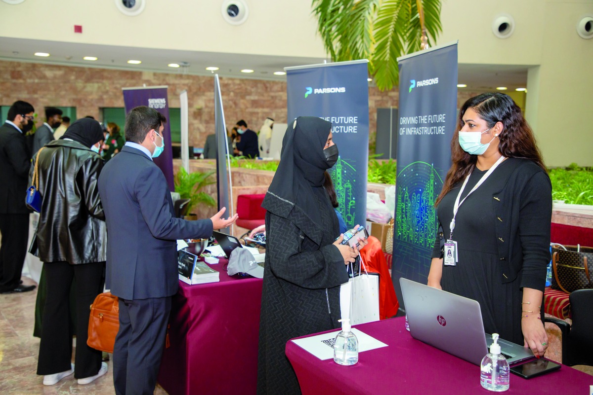Organisation representatives talk with attendees at the job fair hosted at Texas A&M University at Qatar.