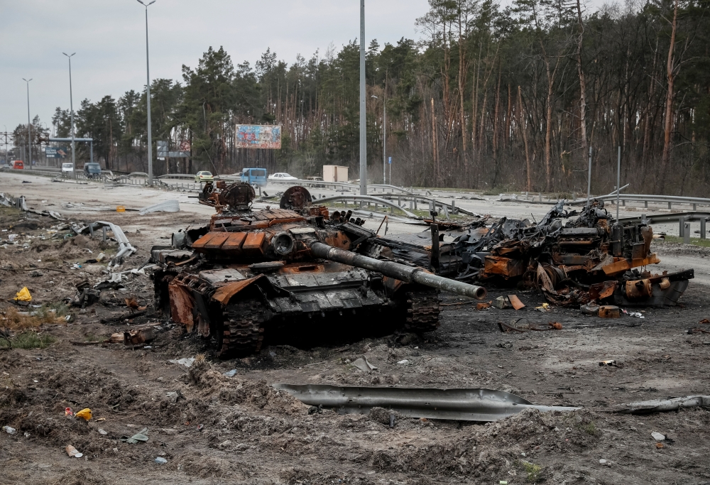 A destroyed Russian tank is seen on a highway, as Russia's attack on Ukraine continues, in Kyiv region, Ukraine, April 5, 2022. REUTERS/Gleb Garanic
