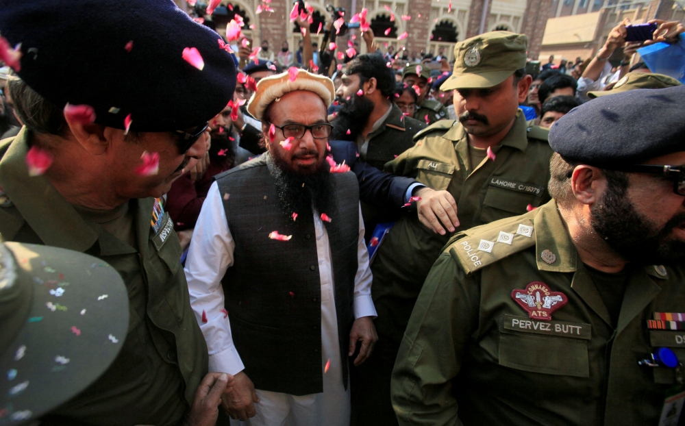 File photo: Hafiz Saeed is showered with flower petals as he walks to court before a Pakistani court ordered his release from house arrest in Lahore, Pakistan November 22, 2017. Reuters/Mohsin Raza/File Photo