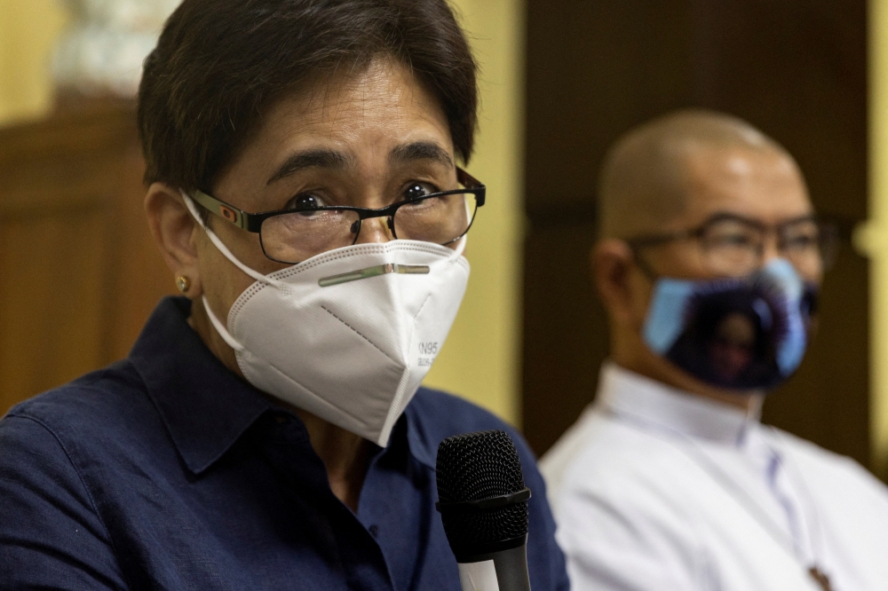 Forensic pathologist Raquel Fortun discusses findings on drug war deaths beside Catholic priest Flavie Villanueva, who counsels drug war victims, during a news conference in Manila, Philippines, April 12, 2022. REUTERS/Eloisa Lopez
