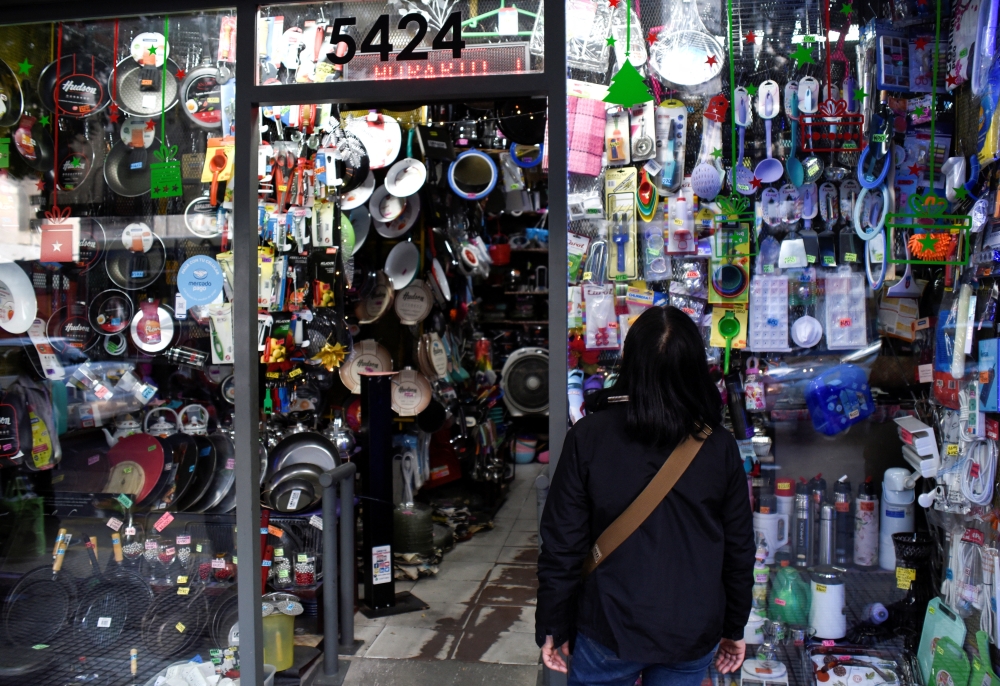 A woman looks into the shop window of a home goods store as inflation in Argentina hits its highest level in years, causing food prices to spiral, in Buenos Aires, Argentina April 12, 2022. Picture taken April 12, 2022. REUTERS/Mariana Nedelcu