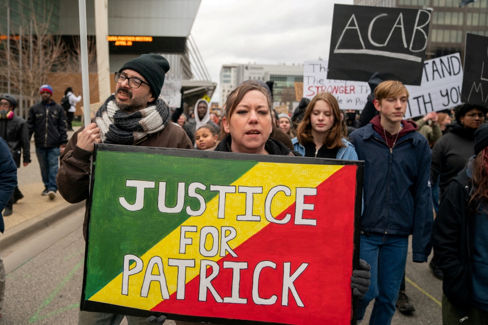 Demonstrators protest the killing of Patrick Lyoya, an unarmed Black man who was shot and killed by a Grand Rapids Police officer during a traffic stop on April 4, in Grand Rapids, Michigan, U.S., April 16, 2022. REUTERS/David 'Dee' Delgado
