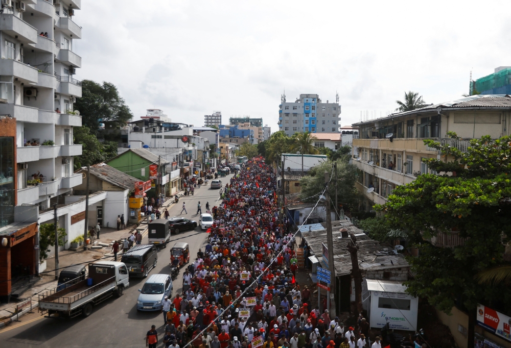 Members and supporters of Sri Lanka's opposition the National People's Power Party march towards Colombo from Beruwala, during a protest against Sri Lankan President Gotabaya Rajapaksa, amid the country's economic crisis, in Colombo, Sri Lanka April 19, 2022. REUTERS/Navesh Chitrakar