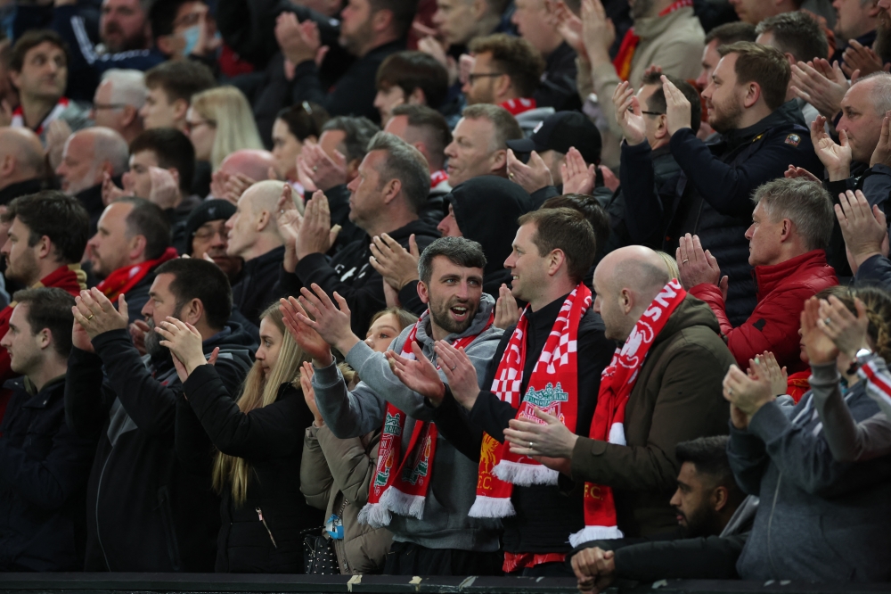 Liverpool fans applaud on the seventh minute for Manchester United 's Cristiano Ronaldo and his family REUTERS/Phil Noble