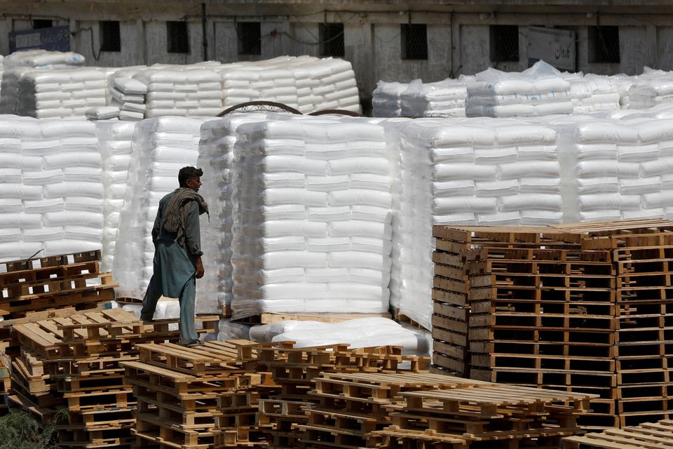 A laborer stands near the cargo supply at a warehouse near the port area in Karachi, Pakistan May 13, 2020. REUTERS/Akhtar Soomro/File Photo