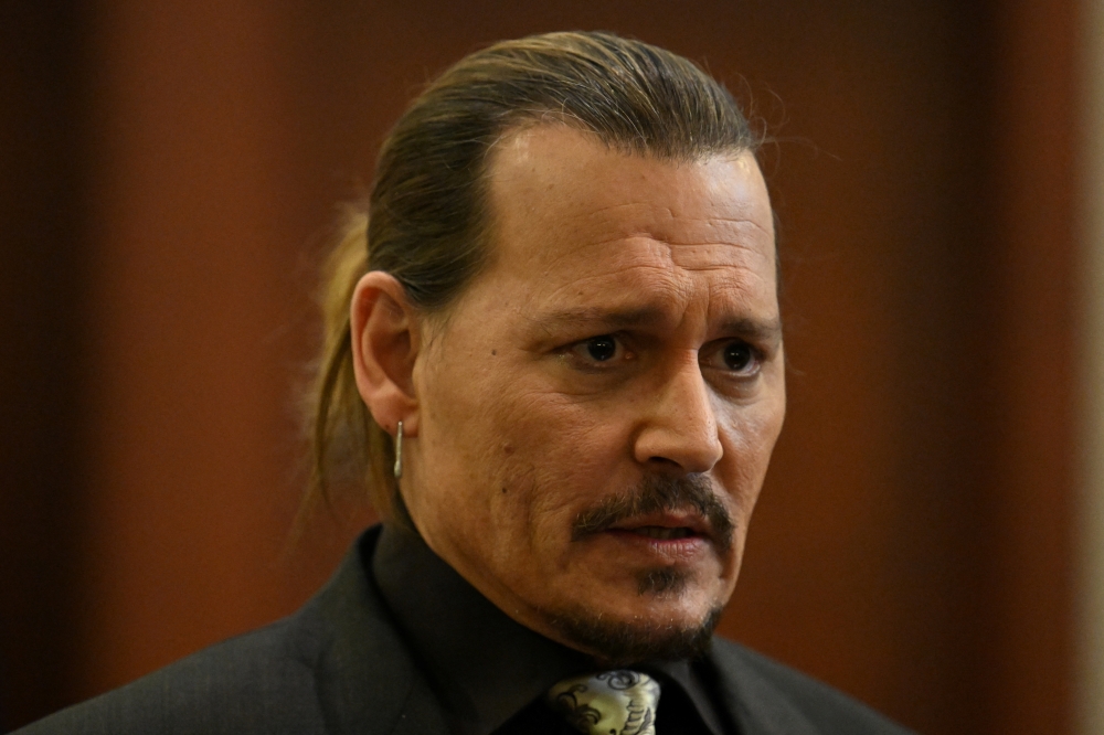 Actor Johnny Depp looks on at the Fairfax County Circuit Courthouse as his defamation case against ex-wife Amber Heard continues, in Fairfax, Virginia, U.S., April 19, 2022. Jim Watson/Pool via REUTERS