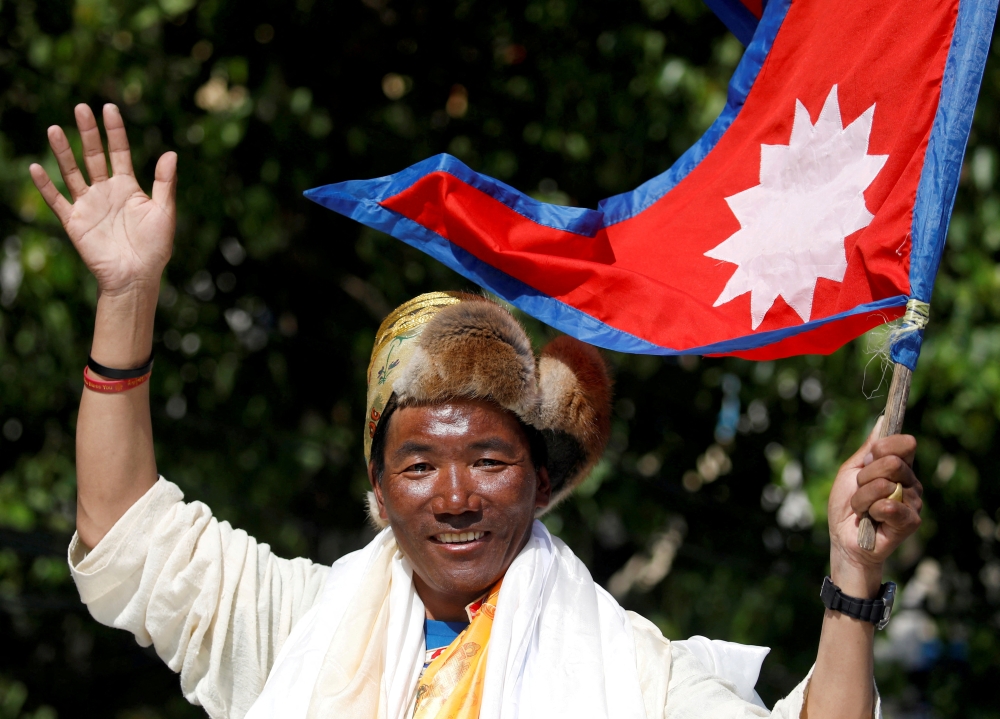Kami Rita Sherpa, a Nepali mountaineer, waves towards media in Kathmandu, Nepal May 25, 2019. Kami Rita summited Mount Everest on May 7, 2022, for a record 26th time, beating his own record set last year, REUTERS/Navesh Chitrakar/File Photo