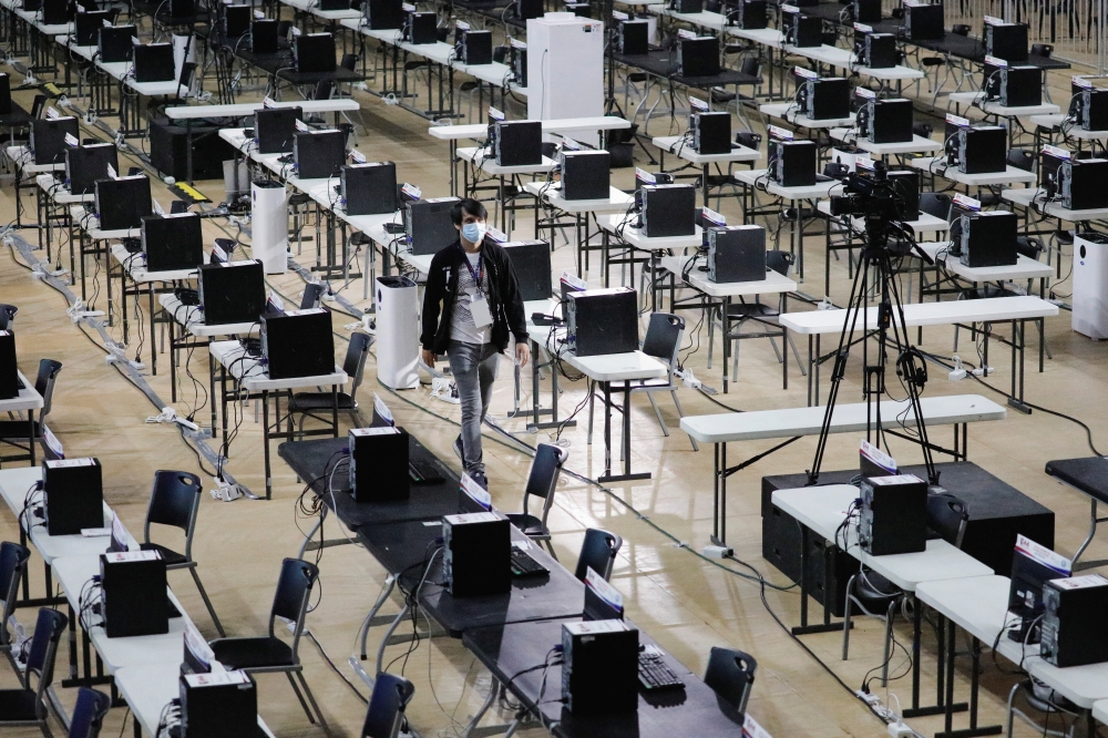 A staff member walks among computers at the Parish Pastoral Council for Responsible Voting (PPCRV), a command center of the election watchdog, a day prior to the national elections in Manila, Philippines, May 8, 2022. REUTERS/Willy Kurniawan