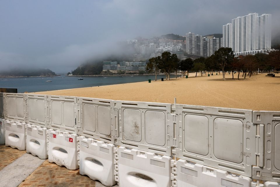 Fences are placed to block access to Deep Water Bay beach during the coronavirus disease (COVID-19) pandemic, in Hong Kong, China, March 18, 2022. REUTERS/Tyrone Siu

