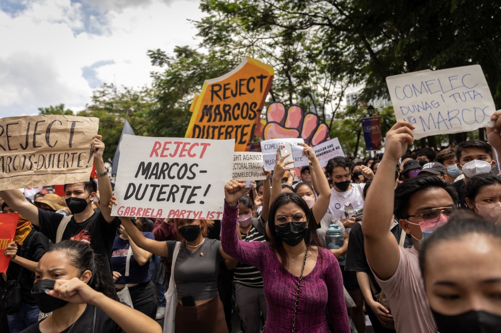 Students and activists gather outside the Commission on Elections to protest its unofficial tally of the national elections, showing presidential candidate Ferdinand 