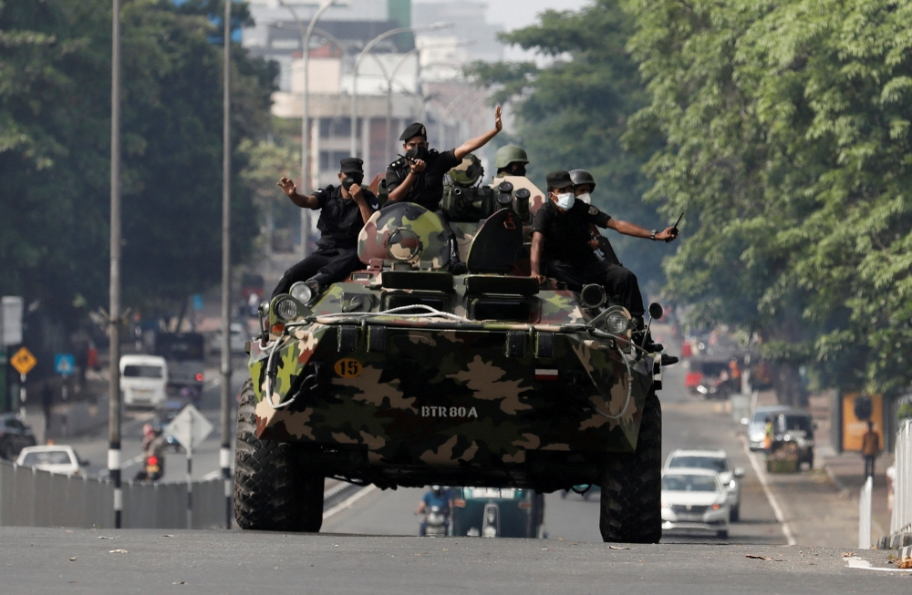 Army members travel on an armoured car on the main road after the curfew was extended for another extra day following a clash between anti-government demonstrators and Sri Lanka's ruling party supporters, amid the country's economic crisis, in Colombo, Sri Lanka, May 11, 2022. Reuters/Dinuka Liyanawatte