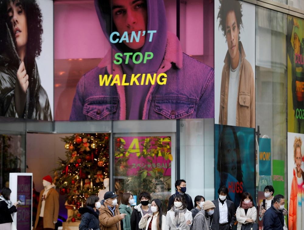 People wear protective masks in a shopping district amid the coronavirus disease (COVID-19) outbreak in Tokyo, Japan, December 14 , 2020. REUTERS/Kim Kyung-Hoon/File Photo