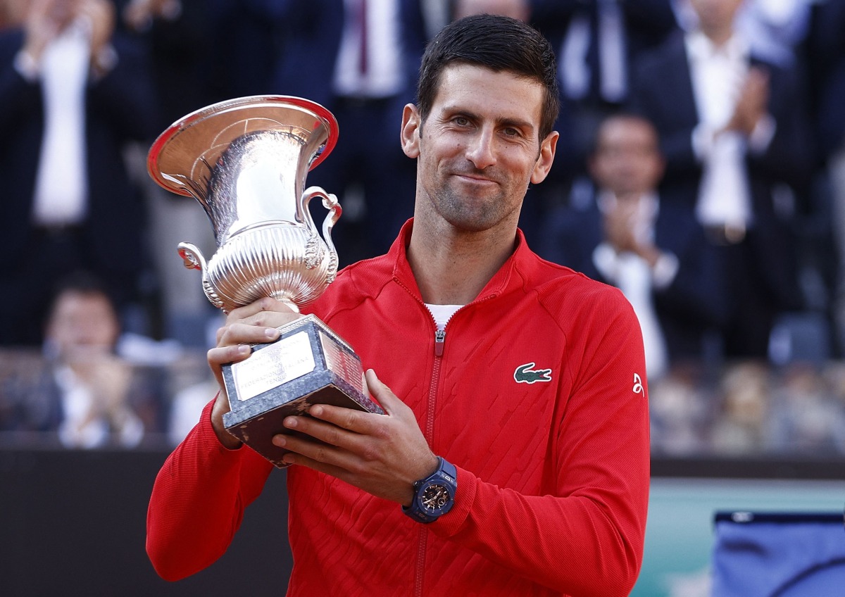  Serbia's Novak Djokovic celebrates with the trophy after winning the final against Greece's Stefanos Tsitsipas REUTERS/Guglielmo Mangiapane