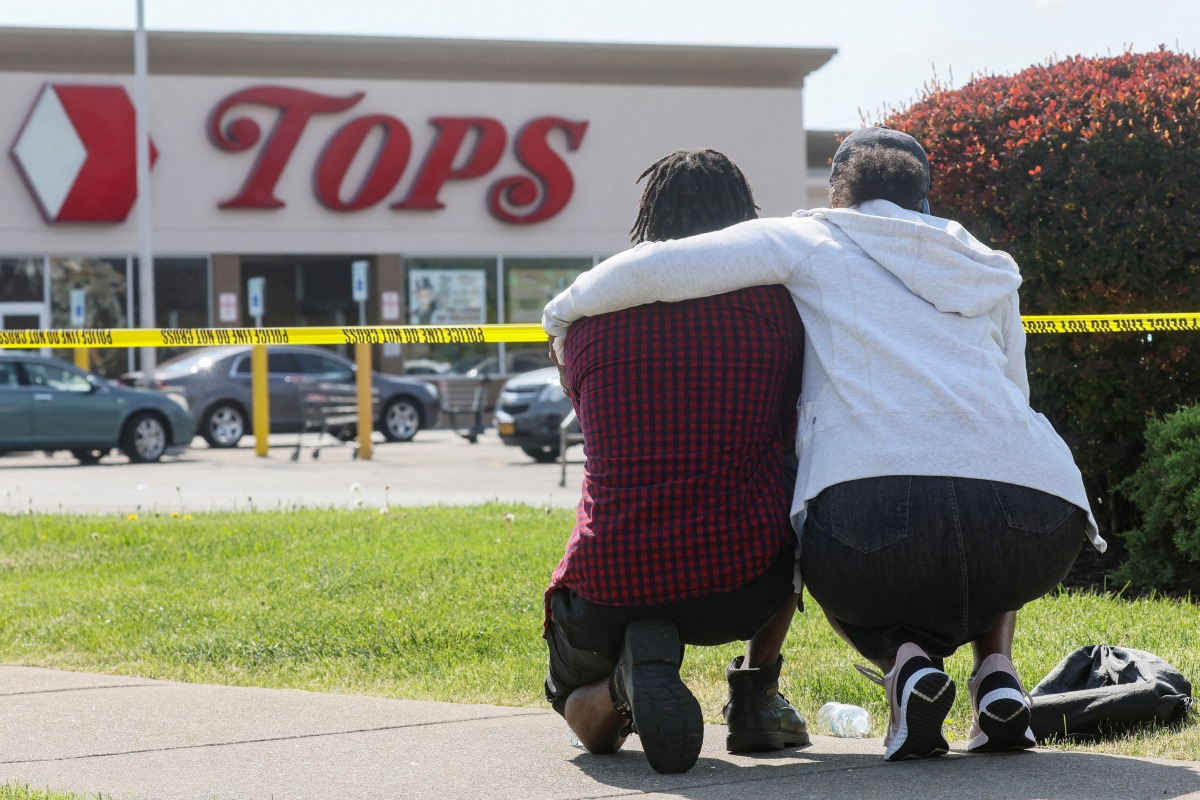 Mourners react while attending a vigil for victims of the shooting at a TOPS supermarket in BUFFALO, New York, U.S. May 15, 2022. REUTERS/Brendan McDermid TPX IMAGES OF THE DAY
