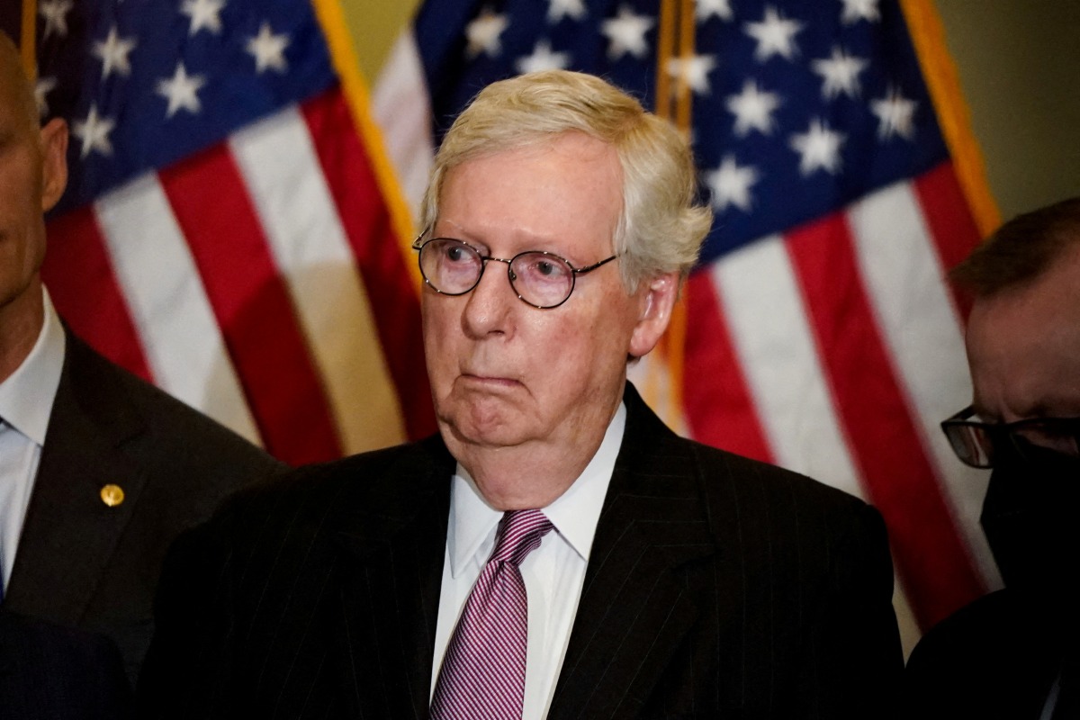 FILE PHOTO: U.S. Senate Minority Leader Mitch McConnell (R-KY) listens as another Republican senator speaks to reporters following the Senate Republicans weekly policy lunch at the U.S. Capitol in Washington, U.S., May 10, 2022. REUTERS/Elizabeth Frantz/File Photo
